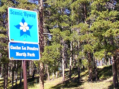 Entrance sign for Cache La Poudre Scenic Byway in Autumn